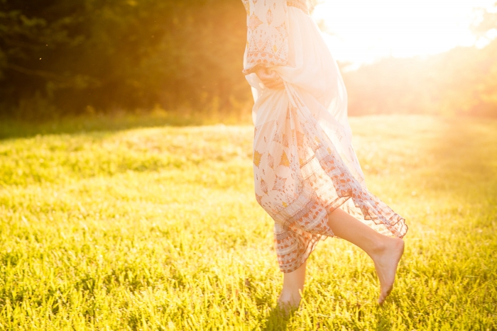 girl in field with sunlight