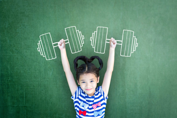 Kid laying on the ground and arms look like they're holding weights but it's a chalk outline of weights