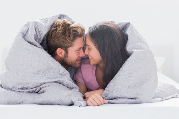 couple nose to nose under covers