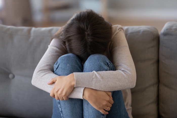 girl with head on knees, hugging knees