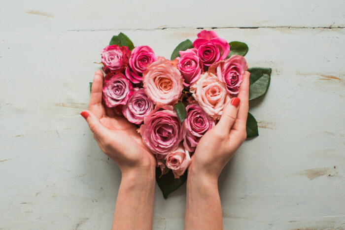A heart of roses in a person's hands