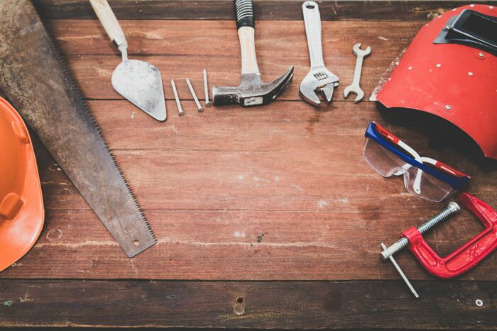 various tools for building things are layed out on a table next to a safety mask and goggles