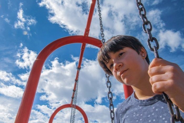 teen on swing