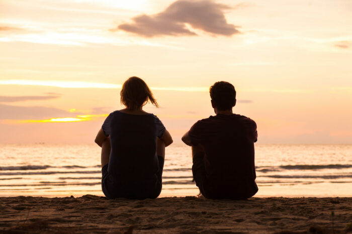 friendship, friends sitting together on the beach