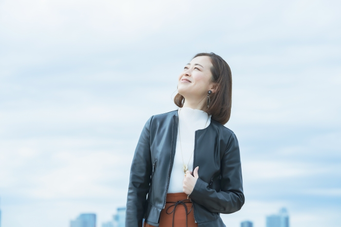 woman looking happily at the sky