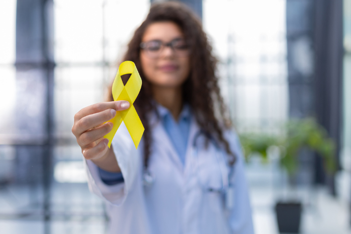 person holding a yellow ribbon